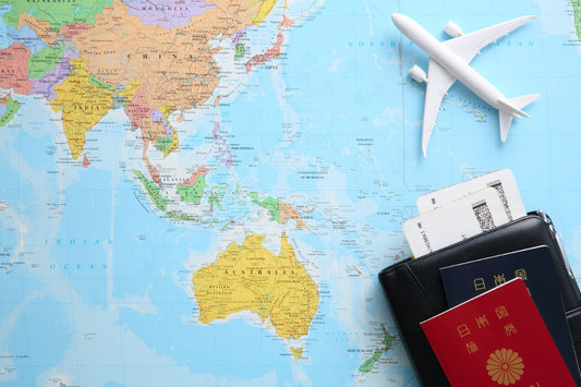 Flat lay of airplane, map, and passports representing animal-based travel nutrition and Hunghee Energy