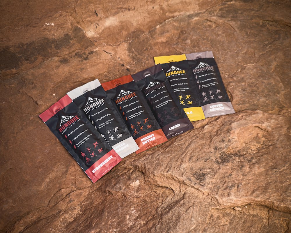 Hunghee Ancestral Energy packs in all flavors displayed on red rock – animal-based energy snacks made with raw honey, ghee, and sea salt