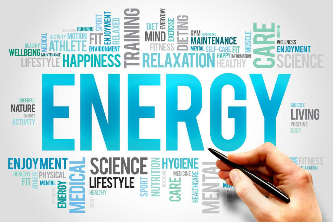 Hand holding a pen near the word ENERGY in a wellness word cloud, energy