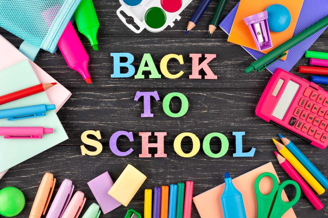 Colorful school supplies flat lay with BACK TO SCHOOL lettering, idea for back-to-school snacks