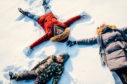 family making snow angels on a sunny winter day supporting circadian rhythm and mood